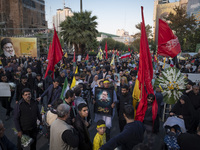 An Iranian protester carries a portrait of Islamic Revolutionary Guard Corps' (IRGC) Quds Force commander, General Abbas Nilforoushan, durin...