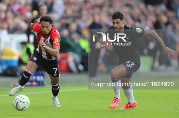 Emerson Palmieri of West Ham chases Brentford's Kevin Schade during the Premier League match between Brentford and West Ham United at the Gt...