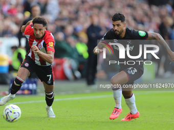 Emerson Palmieri of West Ham chases Brentford's Kevin Schade during the Premier League match between Brentford and West Ham United at the Gt...