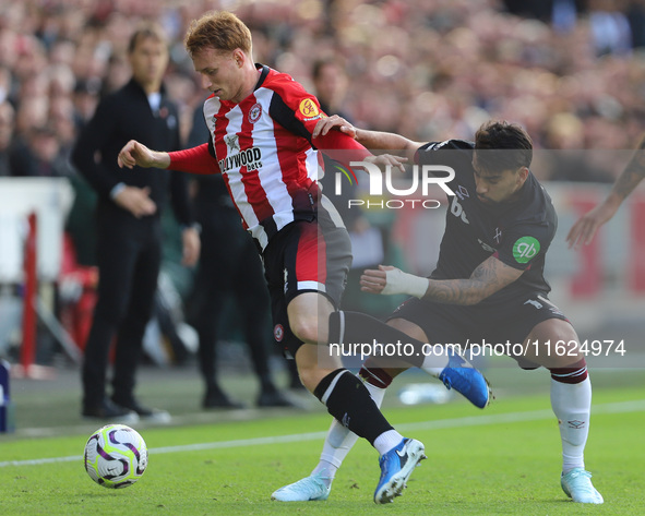 Lucas Paqueta of West Ham tackles Sepp Van den Berg of Brentford during the Premier League match between Brentford and West Ham United at th...