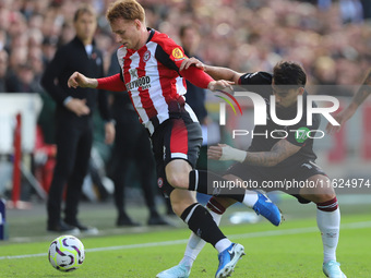 Lucas Paqueta of West Ham tackles Sepp Van den Berg of Brentford during the Premier League match between Brentford and West Ham United at th...