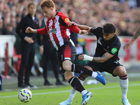 Lucas Paqueta of West Ham tackles Sepp Van den Berg of Brentford during the Premier League match between Brentford and West Ham United at th...