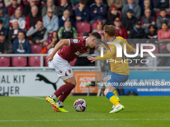 Northampton Town's Aaron McGowan is fouled by Mansfield Town's Stephen Quinn during the first half of the Sky Bet League 1 match between Nor...