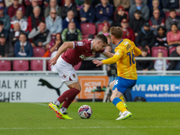 Northampton Town's Aaron McGowan is fouled by Mansfield Town's Stephen Quinn during the first half of the Sky Bet League 1 match between Nor...