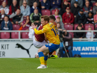 Northampton Town's Aaron McGowan is fouled by Mansfield Town's Stephen Quinn during the first half of the Sky Bet League 1 match between Nor...