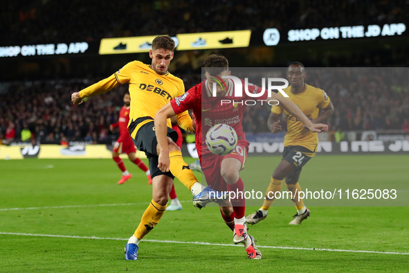 Liverpool's Diogo Jota is in action with Santiago Bueno of Wolverhampton Wanderers during the Premier League match between Wolverhampton Wan...