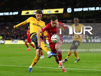 Liverpool's Diogo Jota is in action with Santiago Bueno of Wolverhampton Wanderers during the Premier League match between Wolverhampton Wan...