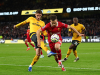 Liverpool's Diogo Jota is in action with Santiago Bueno of Wolverhampton Wanderers during the Premier League match between Wolverhampton Wan...