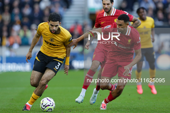 Rayan Ait-Nouri of Wolves (L) battles with Trent Alexander-Arnold of Liverpool during the Premier League match between Wolverhampton Wandere...