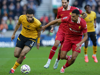 Rayan Ait-Nouri of Wolves (L) battles with Trent Alexander-Arnold of Liverpool during the Premier League match between Wolverhampton Wandere...