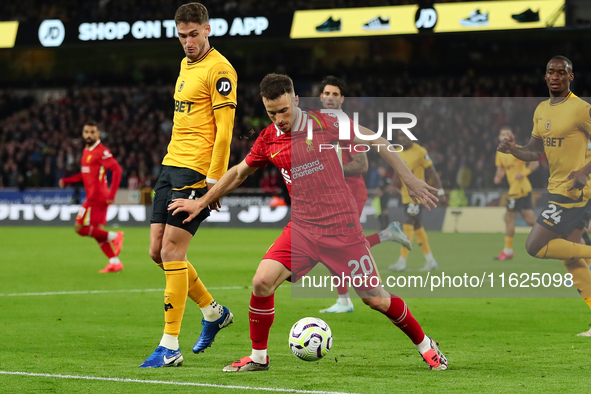 Liverpool's Diogo Jota is in action with Santiago Bueno of Wolverhampton Wanderers during the Premier League match between Wolverhampton Wan...