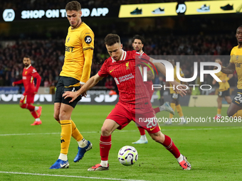 Liverpool's Diogo Jota is in action with Santiago Bueno of Wolverhampton Wanderers during the Premier League match between Wolverhampton Wan...