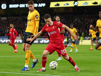 Liverpool's Diogo Jota is in action with Santiago Bueno of Wolverhampton Wanderers during the Premier League match between Wolverhampton Wan...