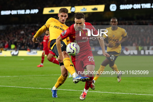 Liverpool's Diogo Jota is in action with Santiago Bueno of Wolverhampton Wanderers during the Premier League match between Wolverhampton Wan...