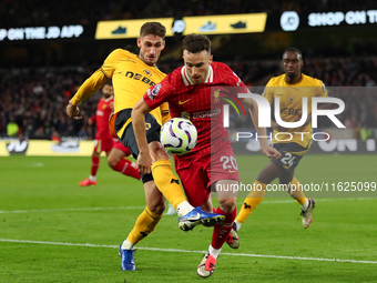 Liverpool's Diogo Jota is in action with Santiago Bueno of Wolverhampton Wanderers during the Premier League match between Wolverhampton Wan...