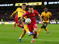 Liverpool's Diogo Jota is in action with Santiago Bueno of Wolverhampton Wanderers during the Premier League match between Wolverhampton Wan...