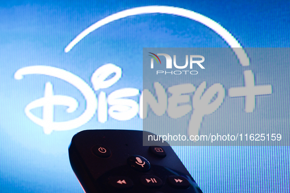 Disney+ app displayed on a tv screen and a remote control are seen in this illustration photo taken in Krakow, Poland on September 30, 2024....