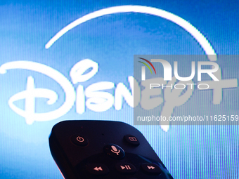 Disney+ app displayed on a tv screen and a remote control are seen in this illustration photo taken in Krakow, Poland on September 30, 2024....