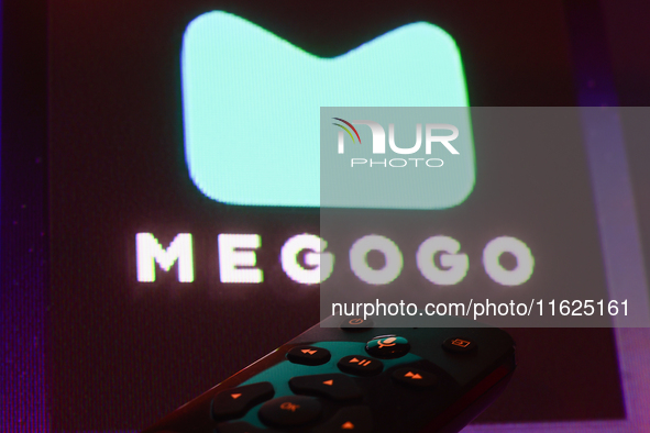 Megogo app displayed on a tv screen and a remote control are seen in this illustration photo taken in Krakow, Poland on September 30, 2024. 