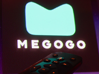 Megogo app displayed on a tv screen and a remote control are seen in this illustration photo taken in Krakow, Poland on September 30, 2024....