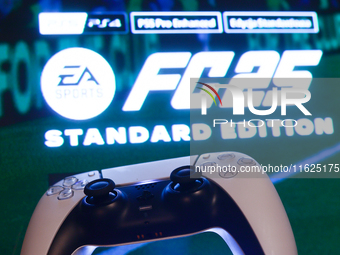 EA Sports FC 25 displayed on a tv screen and  DualSense controller are seen in this illustration photo taken in Krakow, Poland on September...