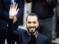 El Salvador's President Nayib Bukele waves as he attends an event at the monument to Libertador General San Martin in Buenos Aires, Argentin...