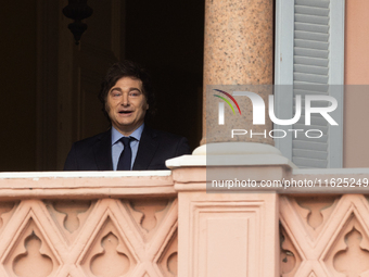 Argentina's President Javier Milei looks on from a balcony of the Casa Rosada Government House after a meeting with El Salvador's President...