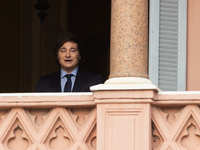 Argentina's President Javier Milei looks on from a balcony of the Casa Rosada Government House after a meeting with El Salvador's President...