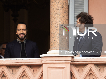 Argentina's President Javier Milei stands next to El Salvador's President Nayib Bukele on a balcony of the Casa Rosada Government House in B...