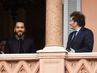 Argentina's President Javier Milei stands next to El Salvador's President Nayib Bukele on a balcony of the Casa Rosada Government House in B...