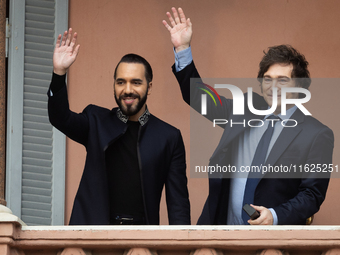 Argentina's President Javier Milei and El Salvador's President Nayib Bukele wave from a balcony of the Casa Rosada Government House in Bueno...