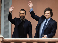 Argentina's President Javier Milei and El Salvador's President Nayib Bukele wave from a balcony of the Casa Rosada Government House in Bueno...