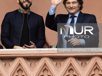 Argentina's President Javier Milei and El Salvador's President Nayib Bukele gesture from a balcony of the Casa Rosada Government House in Bu...