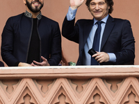 Argentina's President Javier Milei and El Salvador's President Nayib Bukele gesture from a balcony of the Casa Rosada Government House in Bu...