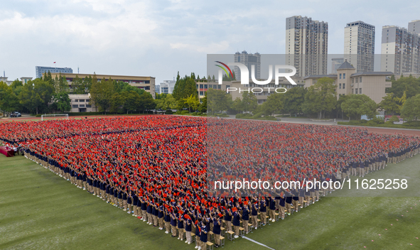 In Suqian, China, on September 30, 2024, 7,000 teachers and students gather at the campus sports field to hold a themed event called ''Repor...