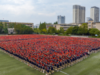 In Suqian, China, on September 30, 2024, 7,000 teachers and students gather at the campus sports field to hold a themed event called ''Repor...