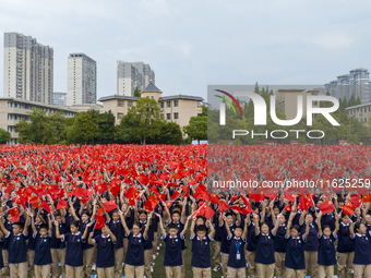 In Suqian, China, on September 30, 2024, 7,000 teachers and students gather at the campus sports field to hold a themed event called ''Repor...