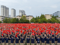 In Suqian, China, on September 30, 2024, 7,000 teachers and students gather at the campus sports field to hold a themed event called ''Repor...