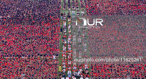 In Suqian, China, on September 30, 2024, 7,000 teachers and students gather at the campus sports field to hold a themed event called ''Repor...