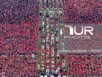 In Suqian, China, on September 30, 2024, 7,000 teachers and students gather at the campus sports field to hold a themed event called ''Repor...