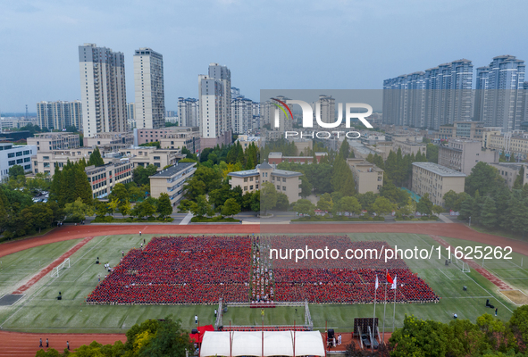 In Suqian, China, on September 30, 2024, 7,000 teachers and students gather at the campus sports field to hold a themed event called ''Repor...