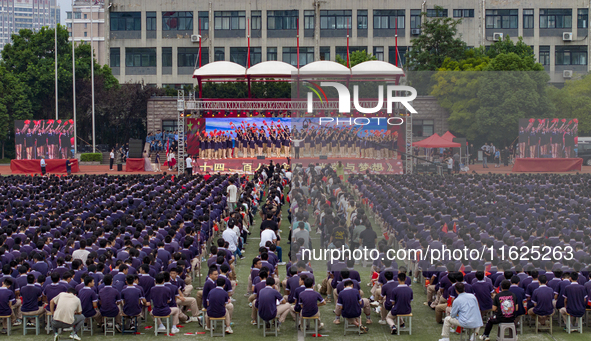 In Suqian, China, on September 30, 2024, 7,000 teachers and students gather at the campus sports field to hold a themed event called ''Repor...