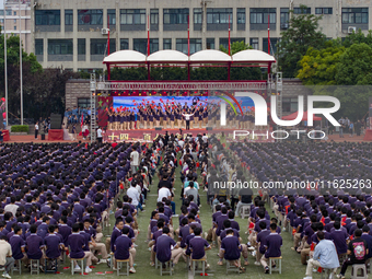 In Suqian, China, on September 30, 2024, 7,000 teachers and students gather at the campus sports field to hold a themed event called ''Repor...