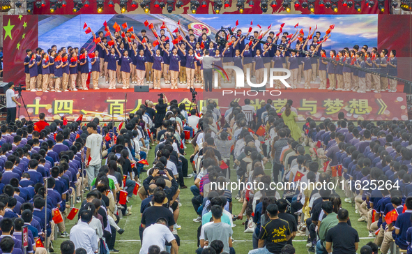 In Suqian, China, on September 30, 2024, 7,000 teachers and students gather at the campus sports field to hold a themed event called ''Repor...