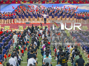 In Suqian, China, on September 30, 2024, 7,000 teachers and students gather at the campus sports field to hold a themed event called ''Repor...