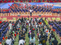 In Suqian, China, on September 30, 2024, 7,000 teachers and students gather at the campus sports field to hold a themed event called ''Repor...