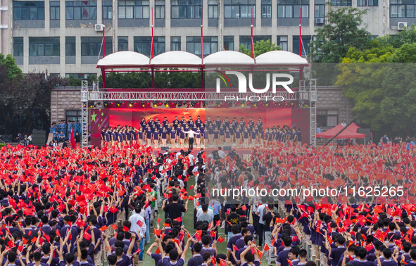 In Suqian, China, on September 30, 2024, 7,000 teachers and students gather at the campus sports field to hold a themed event called ''Repor...