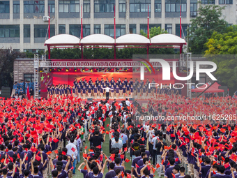 In Suqian, China, on September 30, 2024, 7,000 teachers and students gather at the campus sports field to hold a themed event called ''Repor...