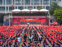 In Suqian, China, on September 30, 2024, 7,000 teachers and students gather at the campus sports field to hold a themed event called ''Repor...