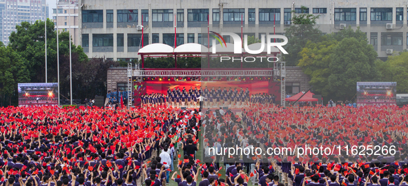 In Suqian, China, on September 30, 2024, 7,000 teachers and students gather at the campus sports field to hold a themed event called ''Repor...